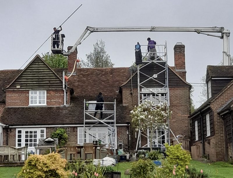 The Roof Moss Cleaners using cherry picker and scaffolding to clean roof safely and professionally in Benson, Oxfordshire